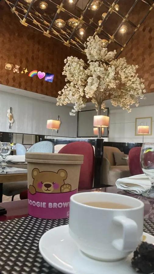 Boogie Brown bucket on a restaurant table beside a cup of tea