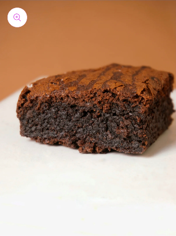 Thick Fudge Brownie cut open revealing a gooey chocolate center